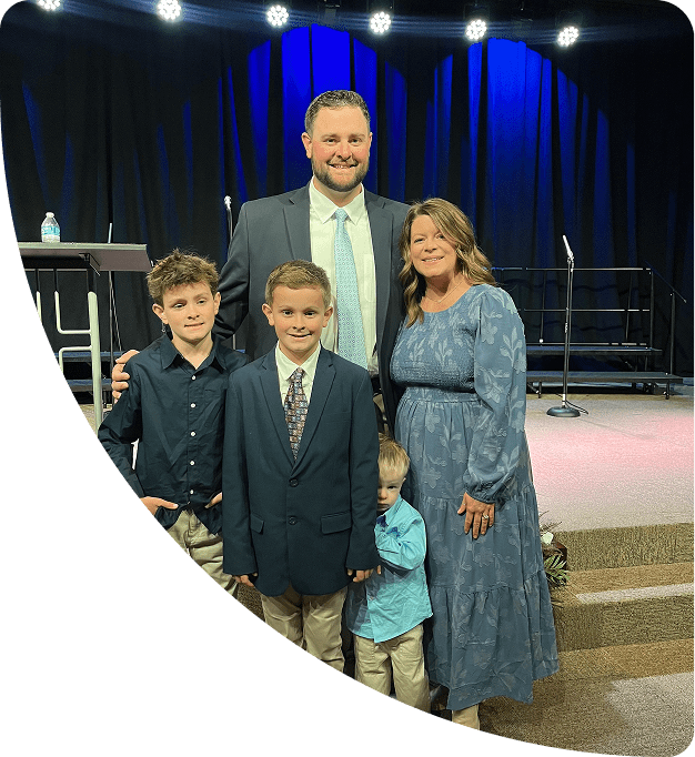 Joey and his family taking a photo together.